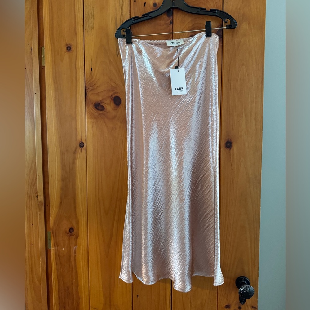 Person’s light pink metallic midi skirt - elastic waistband
